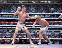 two boxers are fighting in a boxing ring